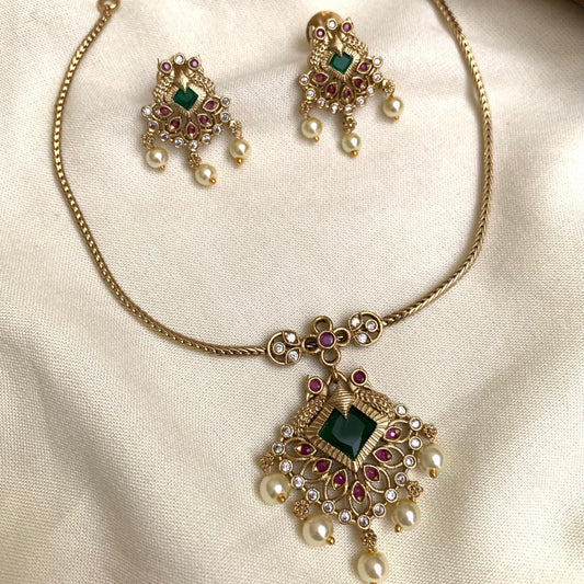 Jewelry set with necklace and earrings on a light fabric background