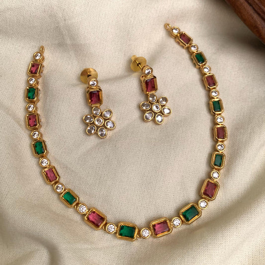 Jewelry set with necklace and earrings on a beige fabric background