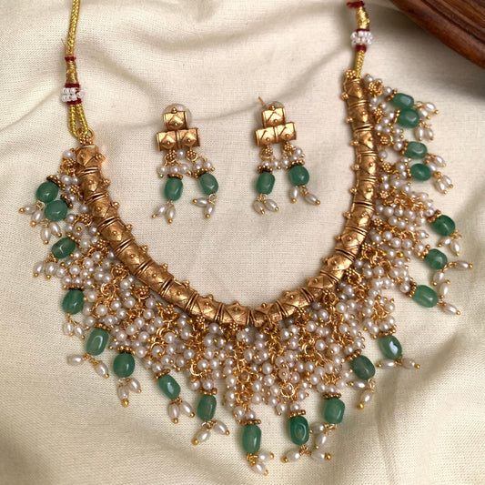 Jewelry set with necklace and earrings on a beige fabric background